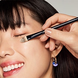 photo of woman applying concealer makeup pre event prep