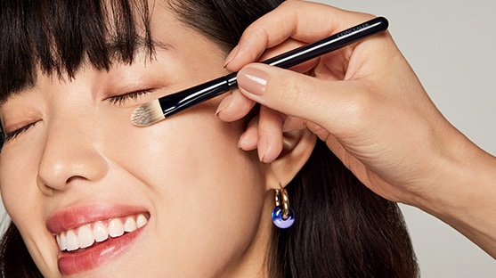 photo of woman applying concealer makeup pre event prep
